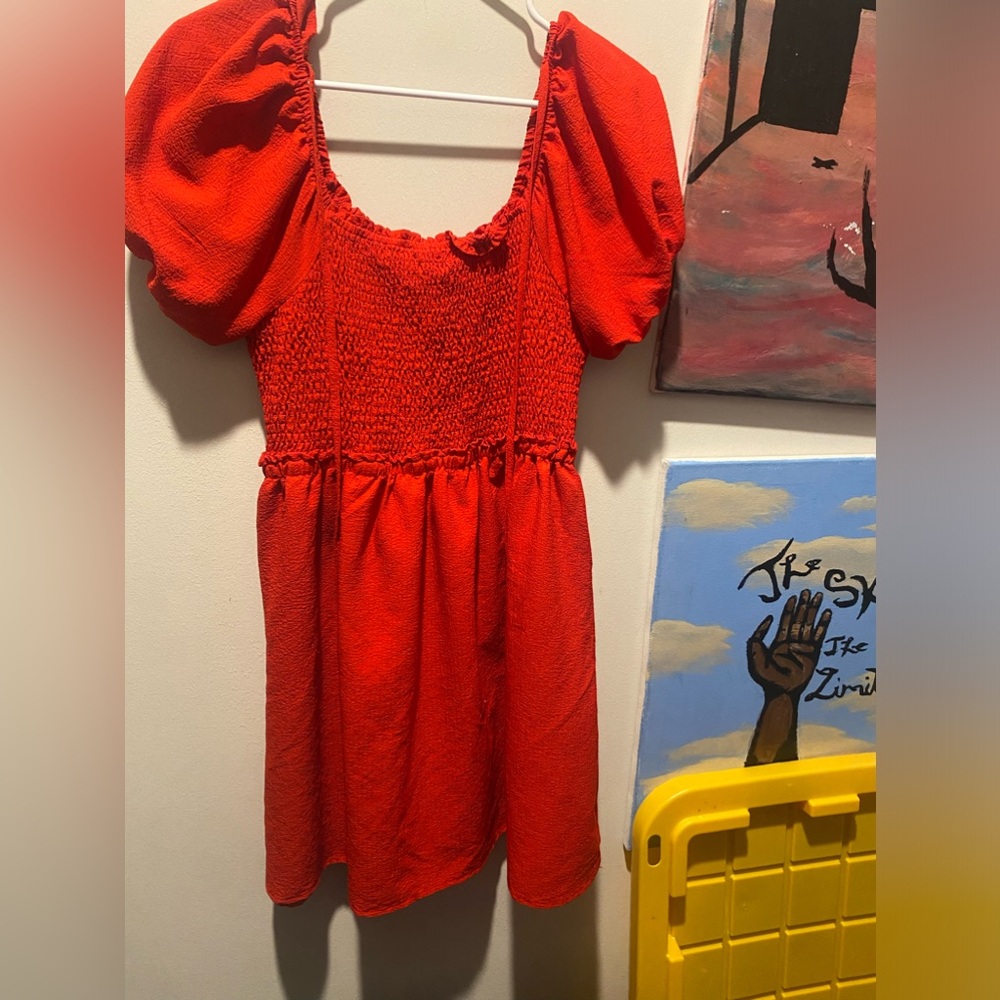 A red dress mini with an open back and puffed shoulder sleeves. I never worn it
